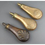 W Bartram, a 19th Century copper and brass powder flask with shell motif 20cm, marked Bartram Nimrod
