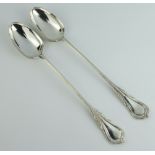 A pair of silver plated lily pattern basting spoons