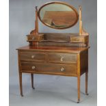 An Edwardian inlaid mahogany dressing table with oval bevelled plate mirror, the base fitted 2 glove