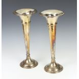 A pair of silver plated tapered posy vases 38cm Both have numerous dents