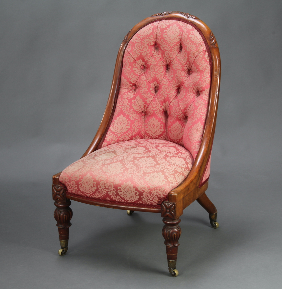 A William IV carved mahogany show frame nursing chair upholstered in red buttoned material, raised