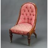 A William IV carved mahogany show frame nursing chair upholstered in red buttoned material, raised