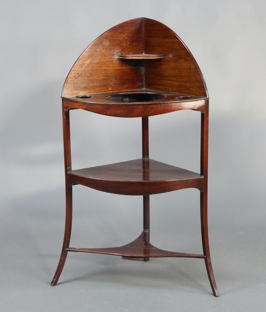 A 19th Century mahogany corner wash stand with raised back fitted 3 bowl recepticals with undertier,