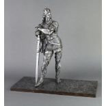A spelter figure of a standing warrior with sword, raised on a rectangular marble base 48cm h x 51cm