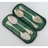 A cased pair of silver plated lily pattern berry spoons, 1 other pair