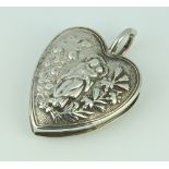 A repousse silver heart shaped wafer box decorated with religious motifs 34.2 grams, 6.5cm London