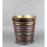 An Edwardian Georgian style circular mahogany plate bucket with swing handle and brass 32cm h x 30cm
