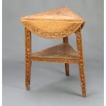 A Victorian carved oak drop flap 2 tier cricket table of triangular form when folded 76cm h x 62cm w