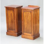 A pair of Edwardian mahogany bedside cabinets, one with raised back (the other is missing), cupboard