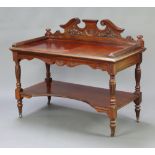 A Victorian carved walnut two tier buffet with shaped raised back, raised on turned supports with