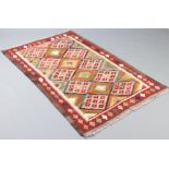 A red, brown and white ground Maimana Kilim rug with all over geometric design 188cm x 118cm