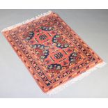 A red and blue ground Afghan rug with 2 stylised medallions to the centre within a 5 row border