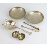 A silver tea strainer 1942, 2 white metal bowls, a salt and a pair of tongs