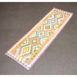 A tan, turquoise, green and purple ground Chobi Kilim runner with 6 diamonds to the centre 240cm x