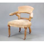 A Victorian light oak show frame tub back chair upholstered in mushroom material, raised on turned