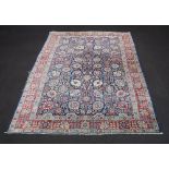 A North West Persian blue ground and floral patterned carpet within a 3 row border 336cm x 230cm