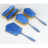 An Art Deco silver and blue guilloche enamel dressing table set comprising 2 hairbrushes, 2