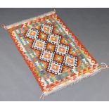 A black, brown and green ground Chobi Kilim rug with 2 rows of 8 diamonds to the centre 134cm x 81cm
