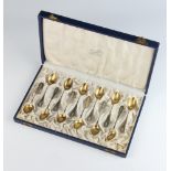 A set of 12 German 800 standard coffee spoons with gilt bowls in a fitted velvet case, 104 grams