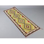 A green, blue and brown ground Maimana Kilim runner with all over geometric design and 4 diamonds to