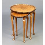 A nest of 2 Queen Anne style quarter veneered coffee tables with pie crust edge, raised on