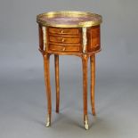 An oval Continental inlaid mahogany bedside chest with pierced brass gallery, fitted 3 long drawers,