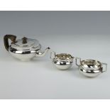 A silver tea set of squat form with ebonised handles, London 1916, gross weight 868 grams