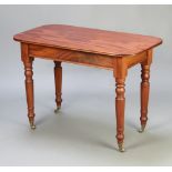 A Victorian oval mahogany occasional table raised on turned supports ending in brass caps and