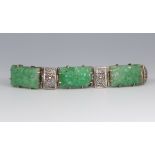 A white metal and 3 plaque carved green hardstone Art Deco bracelet, 16cm The central hardstone