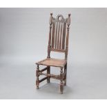 A Victorian, 17th Century style oak hall chair with stick and rail back and solid seat, raised on