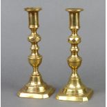 A pair of 19th Century brass candlesticks with knopped stems and ejectors 20cm h x 8cm x 8cm