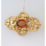 A Victorian yellow metal citrine scroll brooch, 12 grams gross, 60mm x 35mm There are numerous