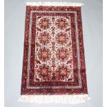 A white, brown and red Persian rug with 8 stylised medallions to the centre within a multi row