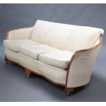 A Victorian style mahogany show frame 3 seat sofa upholstered in yellow floral material, raised on