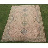 A pink and blue ground machine made carpet with 4 stylised diamonds to the centre 345cm x 269cm