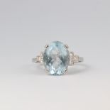 A platinum aquamarine and diamond ring, the centre oval stone 4.5ct, the 6 brilliant cut diamonds