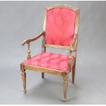 An Italian walnut showframe open armchair, the seat and back upholstered in red material, raised