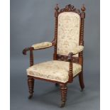 A Victorian walnut open armchair with bobbin turned columns to the side, upholstered seat and
