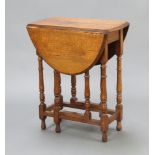 An Edwardian light oak drop flap gateleg tea table, raised on turned supports 73cm h x 60cm w x 31cm