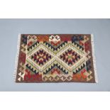 A black, brown and tan ground Maimana Kilim rug with diamonds to the centre 92cm x 63cm