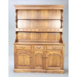A 17th Century style oak dresser, the upper section with moulded cornice, fitted a shelf above 6