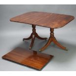 A Georgian style mahogany D end extending dining table with 1 extra leaf, raised on pillar and