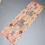 A green, blue and brown ground Chobi Kilim runner with all over geometric design 253cm x 80cm