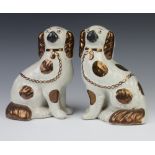 A pair of Victorian style Staffordshire Spaniels with ochre decoration 20cm