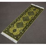 A green and black ground Belgian cotton runner with 5 diamonds to the centre 209cm x 72cm