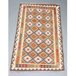 A brown, black and white ground, Maimana Kilim with overall geometric design 193cm x 124cm