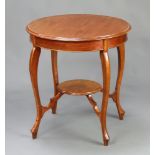 An Edwardian circular oval 2 tier occasional table raised on cabriole supports 73cm h x 67cm diam.