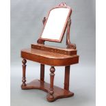 A Victorian mahogany Duchess dressing table with arch shaped plate mirror, the base fitted 3 glove