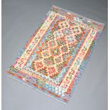 A white, blue and brown ground Chobi Kilim rug with all over geometric design within a multi row