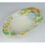 A Clarice Cliff moulded dish decorated with buttercups having a basket weave handle, no.89A